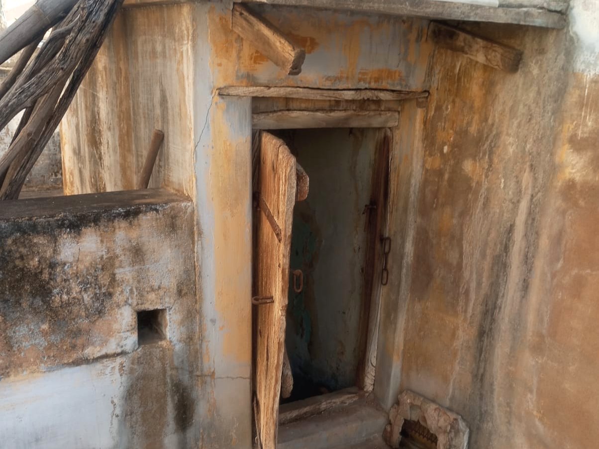 Aged terrace access doorway requiring repair at the Thirumaligai